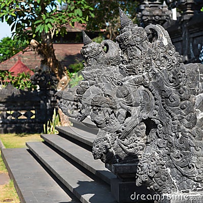 Traditional Balinese stone dragon image in the temple Stock Photo