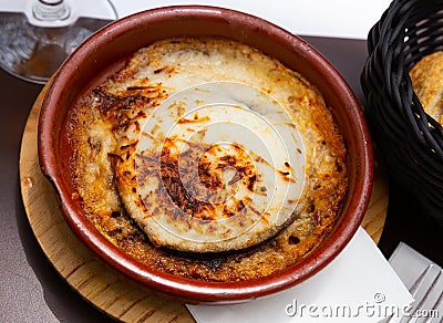 Traditional Balkan Moussaka dish served with fresh bread in pottery Stock Photo