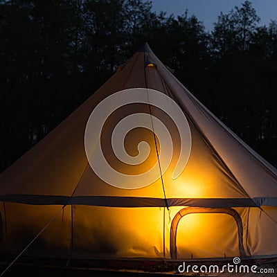 Traditional bell tent glows at night Stock Photo