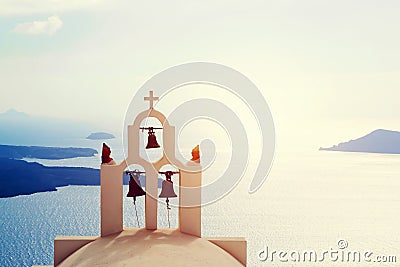 Traditional bells and cross over Aegean sea. Santorini Greece Stock Photo