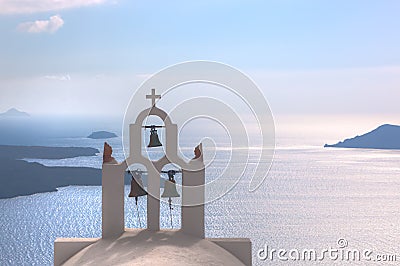 Traditional bells and cross over Aegean sea. Santorini Greece Stock Photo
