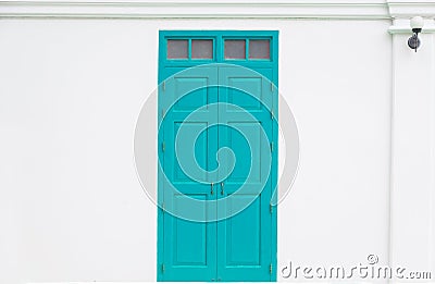 Traditional blue door wooden of an old on white wall Stock Photo