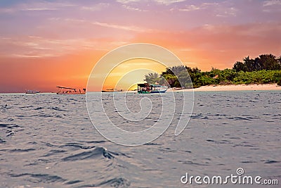 Traditional boats at Gili Meno island beach, Indonesia at sunset Stock Photo