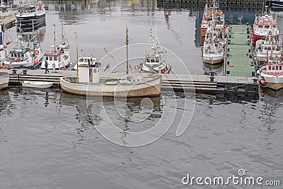 Traditional boats moored at floating quay at artic polar village harbor, Vardo, Norway Editorial Stock Photo