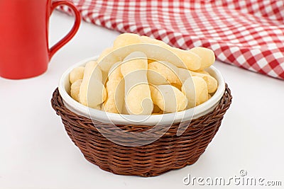 Traditional Brazilian starch biscuit called biscoito de polvilho in a basket in a white background coffe table Stock Photo