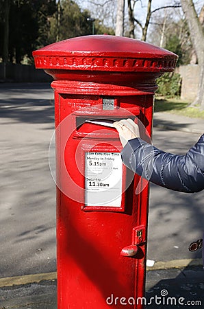 Traditional British red post box Stock Photo