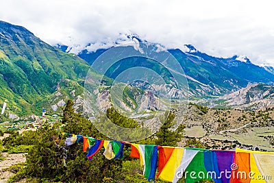 Traditional buddhist prayer flags over foggy mountain background in Ngawal, Nepal Editorial Stock Photo