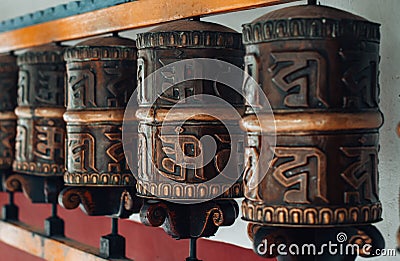 Traditional Buddhist prayer wheels with mantras. Stock Photo