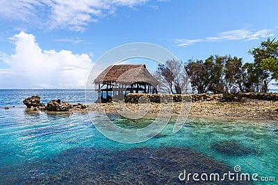 Traditional bungalow of native aborigines Micronesian people. Reef coral island motu. Blue azure turquoise lagoon. Pohnpei island. Stock Photo