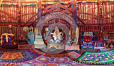 Traditional carpet, rug and pillow treatment details in the interior of a nomadic yurt Stock Photo