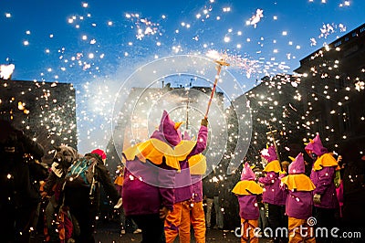 Traditional catalan correfocs celebration with fireworks and people dressed like demons in barcelona city center Editorial Stock Photo