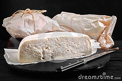 Traditional Caucasian homemade cheese sulguni on stone board, selective focus Stock Photo