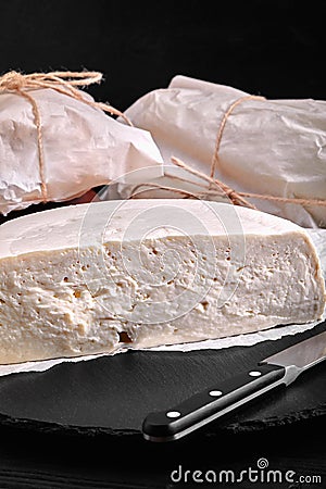 Traditional Caucasian homemade cheese sulguni on stone board, selective focus Stock Photo