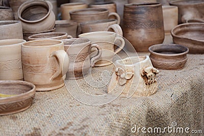 Traditional Ceramic Jugs of Handmade Ceramic Pottery in a Roadside Market with Ceramic Clay Caps Outdoors Stock Photo