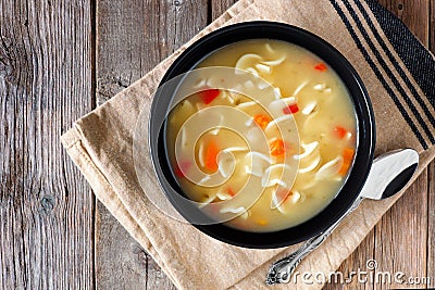 Traditional chicken noodle soup, above scene on rustic wood Stock Photo