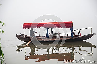 Traditional chinese boat view in Wuhan city Donghu east lake during rainy season Editorial Stock Photo