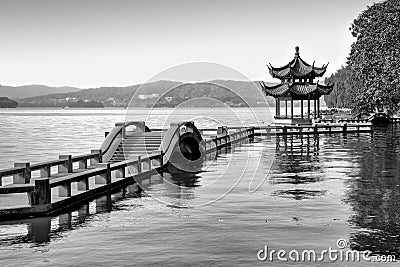 Traditional chinese bridge and pavilion on Hangzhou lake, China, Black and white Stock Photo