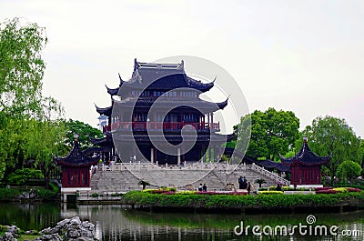 A traditional Chinese building built in modern times, with a large three-story attic, blue tiles and red columns, wooden structure Editorial Stock Photo