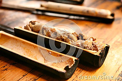 Traditional Chinese dishes of the village Dzhay pilaf with meat, cooked in bamboo. Stock Photo