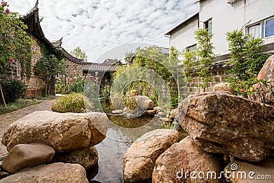 Traditional Chinese garden, a tourist attraction at Wolong College in Changting city, with ancient wood buildings, stones, and sma Stock Photo