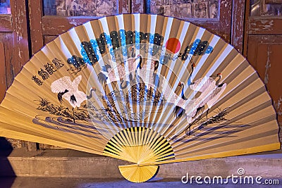 Traditional Chinese paper and bamboo folding hand fan, souvenir from China Stock Photo