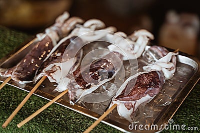 Traditional chinese street food on the wooden skewers Stock Photo