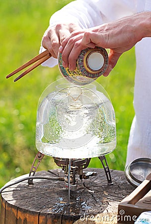 Traditional Chinese tea ceremony, man pours tea from gaiwan into Stock Photo