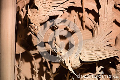 Traditional Chinese woodcarving of two birds fighting Stock Photo