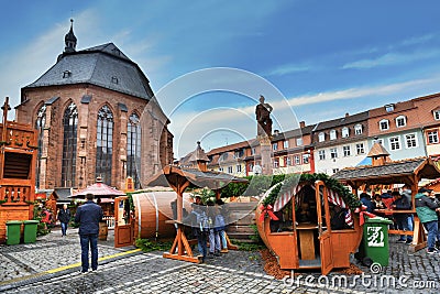 Traditional Christmas market in front of Church of the Holy Spirit called `Heiliggeistkirche` in German at marketplace Editorial Stock Photo