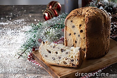 Traditional Christmas panettone with red tie and christmas ornaments on wooden table Stock Photo