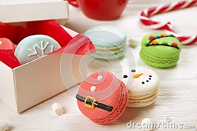 Traditional christmas themed french macaroons sweets in the form of snowman, snowflake, christmas tree and santa`s belly with can Stock Photo