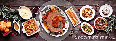 Traditional Christmas turkey dinner. Top view panoramic table scene on a dark wood banner background. Stock Photo