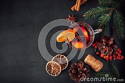 Traditional Christmas warming mulled wine. Hot drink with spices in glass cup on dark background Stock Photo