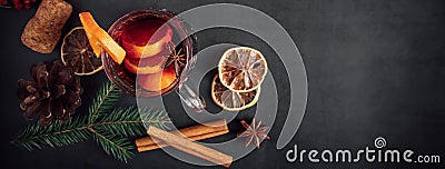 Traditional Christmas warming mulled wine. Hot drink with spices in glass cup on dark background Stock Photo