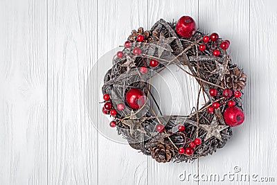 Traditional Christmas wreath from twigs, stars and pine cones with red decorations Stock Photo