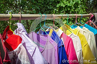 The Traditional clothes in hanger hang on a bamboo shelf. The Shirt hang on bamboo shelf Stock Photo