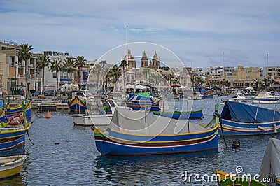 Traditional colorful fishing boats in the harbor of fishing village Marsaxlokk, Malta Editorial Stock Photo