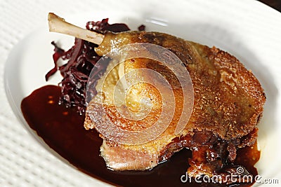 traditional confit french crispy skin on duck leg with braised red cabbage Stock Photo