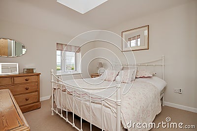 Traditional cottage bedroom with iron bedstead Stock Photo