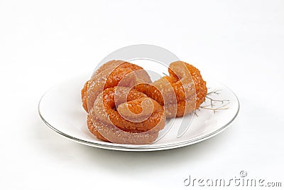 Traditional crispy fun sweet found in Bangladeshi mela. ingridients are Rice powder, sugar,color. Rice Jilabi street food on white Stock Photo