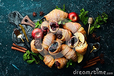 Traditional croissants with jam, chocolate and apple. Sweet pastries. Stock Photo