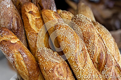 Traditional crusty French bread baguette in basket at bakery. Fresh organic pastry at local market. France cuisine background Stock Photo