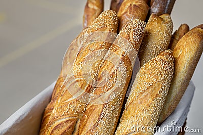 Traditional crusty French bread baguette in basket at bakery. Fresh organic pastry at local market. France cuisine background Stock Photo