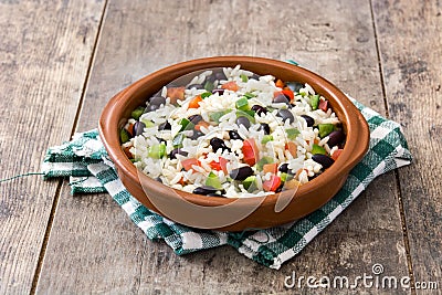 Traditional cuban rice, black beans and pepper on wood. Moros y cristianos. Stock Photo