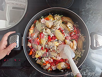 Traditional cuisine on a glass ceramic hob with some chicken wings, top view and empty copy space Stock Photo