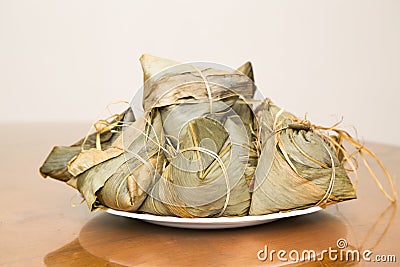 Traditional Duanwu Chinese rice dumplings stacked on plate Stock Photo