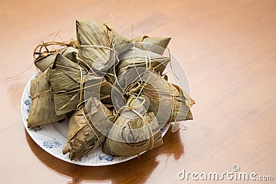 Traditional Duanwu Chinese rice dumplings stacked on plate Stock Photo