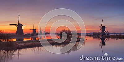 Traditional Dutch windmills at sunrise at the Kinderdijk Stock Photo