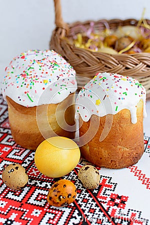 Traditional easter cake kulich Ukrainian style with colored eggs on painted towel Stock Photo