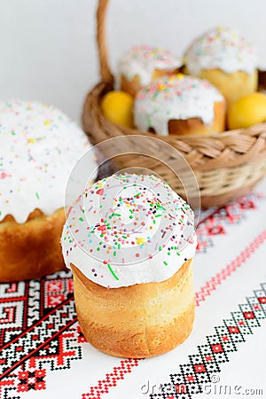 Traditional easter cake kulich Ukrainian style with colored eggs on painted towel Stock Photo